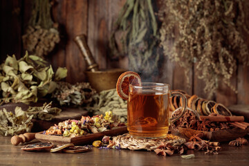 Cup of herbal tea with various dried herbs, flowers, and spices.