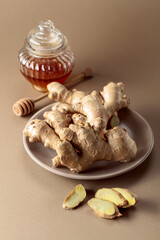 Ginger with honey jar on a beige background.