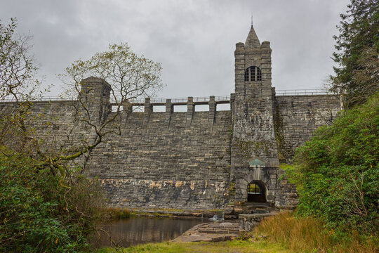 The historic, Grade II listed Upper Neuadd stone dam wall, tunnel outlet and tower with its weathered masonry, on the Taf Fechan river in Bannau Brycheiniog (Brecon Beacons), Powys, Wales