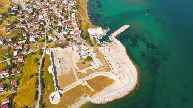 Seddulbahir, Eceabat, Turkey. Restored Ottoman Seddulbahir Fortress (Sedd el Bahr Kale) at Cape Helles on Dardanelles Strait. Clear sunny day. Aerial view, Departure of the camera
