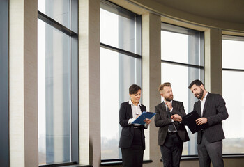 Fototapeta premium Real estate agent and business people watching tablet in modern office, talking to solve rent issues, realtor telling clients to make recommendations and consulting on new property, advice giving