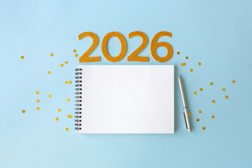 New Year 2026 planning concept with notebook and golden numbers for your goals, plans, resolutions. Flat lay style. Christmas planning concept with space for text