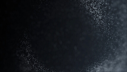 White snow particles swirling in circular motion on dark background. Elegant luminous winter vortex texture for holiday and New Year design.