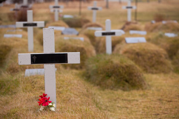 Unique mound cemetery near a turf church in Hofn, Iceland. The ground is volcanic with a thin layer of soil so graves can't be dug 6 feet down. Instead the graves sit above ground 