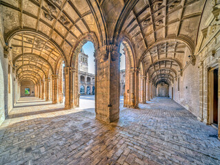 Historic cloister with arches and cobbled floors in Seville