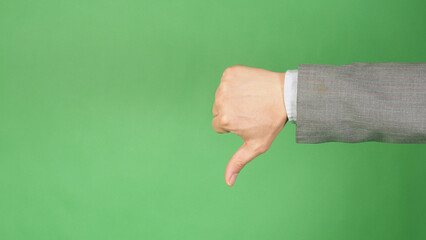 A thumbs down gesture on a green background.