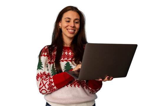 Happy woman wearing christmas sweater using laptop for holiday shopping or virtual festive video call