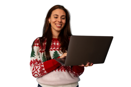 Happy woman wearing christmas sweater using laptop for holiday shopping or virtual festive video call
