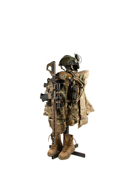 Multicam tactical gear with weapon on stand.