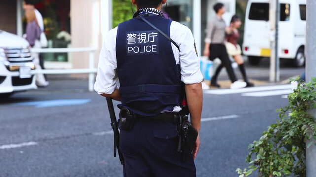 Japanese police squad formation in protective uniform with "Police" logo, policemen patrol maintain public during political demonstration protest rally in the streets of Tokyo city center, Japan