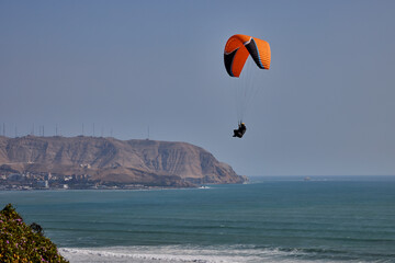 warm sunny afternoon in Miraflores, with the Pacific breeze and El Morro Solar rising in the...