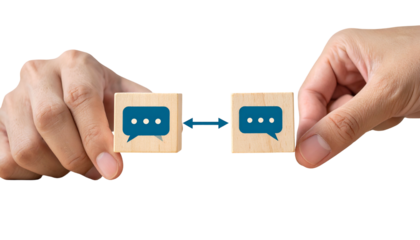 Two hands holding wooden blocks with chat bubbles; an arrow depicts communication