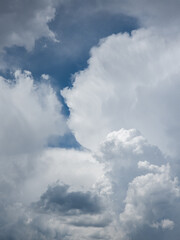 Dramatic clouds fill the vast blue sky, creating a captivating natural scene. The outdoors atmosphere evokes a sense of wonder and tranquility under bright daylight.