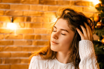 cozy room decorated for the new year and christmas. brick wall with retro lamps, loft style