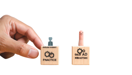 A hand interacts with two wooden blocks, one with gears & "PRACTICE," the other with a smiling finger