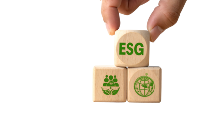 Hand placing ESG cube atop two cubes featuring community and earth icons, all on black