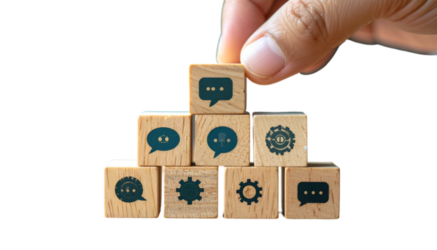 Hand arranging wooden blocks with speech bubbles and gear icons. Black background