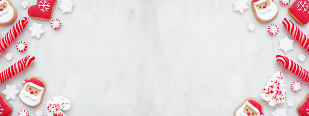 Christmas sweets double border with a collection of red and white cookies and candies. Overhead...