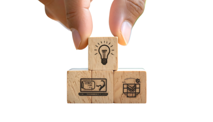 Hand arranging wooden blocks; lightbulb, laptop & email icons shown