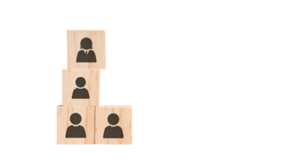 Wooden blocks stacked as a hierarchy with human silhouettes on a black background