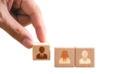 Hand placing wooden block with person icon into a row of blocks