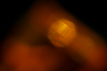 Abstract background loop of fire and flame motion creating a glowing orange and yellow light in the darkness