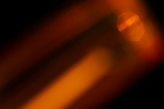 Abstract background loop of fire and flame motion creating a glowing orange and yellow light in the darkness