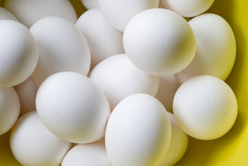 Eggs randomly assorted in a yellow bowl