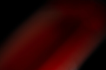 Abstract motion blur of bright red and orange city street lights creating a dark, colorful bokeh fire effect