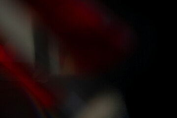 Abstract motion blur of bright red and orange city street lights creating a dark, colorful bokeh fire effect