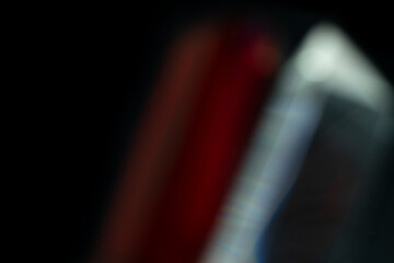 Abstract motion blur of bright red and orange city street lights creating a dark, colorful bokeh fire effect