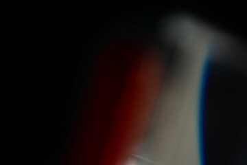 Abstract motion blur of bright red and orange city street lights creating a dark, colorful bokeh fire effect