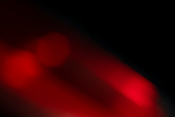 Abstract motion blur of bright red and orange city street lights creating a dark, colorful bokeh fire effect