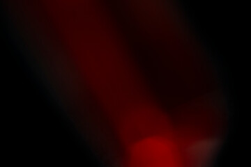 Abstract motion blur of bright red and orange city street lights creating a dark, colorful bokeh fire effect