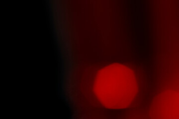 Abstract motion blur of bright red and orange city street lights creating a dark, colorful bokeh fire effect