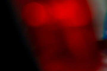 Abstract motion blur of bright red and orange city street lights creating a dark, colorful bokeh fire effect