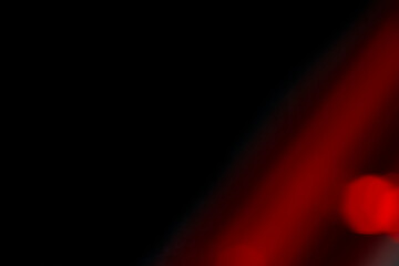 Abstract motion blur of bright red and orange city street lights creating a dark, colorful bokeh fire effect