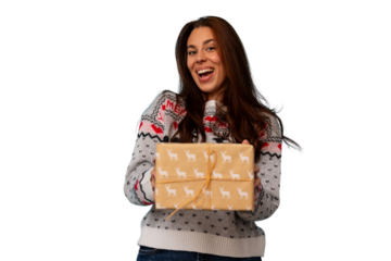 Woman wearing christmas sweater smiling and holding wrapped gift, celebrating holidays, expressing joy and happiness