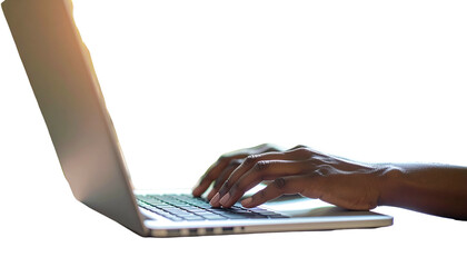 A dark-skinned person's hand typing on a laptop with the keyboard illuminated