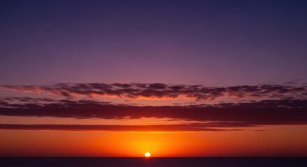 Beautiful sunset over the sea with clouds and orange sky tranquil scene of nature with sun setting on the horizon calm and peaceful seascape at dusk with colorful sky