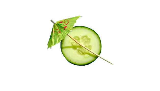 Close-up of cucumber slice with cocktail umbrella against a black background