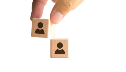 Hand placing a person-icon block onto another, forming a stack of two with black bg