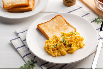 scrambled eggs and toast bread in a plate.Easy high protein meal for breakfast.