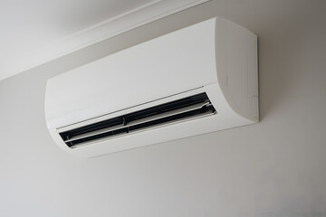 Wall mounted split air conditioner unit in modern interior room, home cooling system installation. Indoor climate control appliance for residential comfort, smart energy efficient air conditioning tec