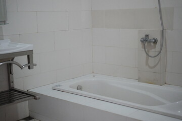 Minimalist bathroom interior design with white tiles and modern fixtures creating a clean, serene space for relaxation and personal care rituals