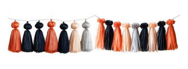 A long garland of handmade tassels in orange, black, and beige, strung together with small lights, isolated on transparent background