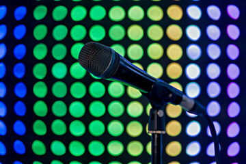 A microphone in front of a colorful background