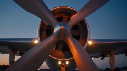 Dramatic low-angle view of a classic aircraft propeller against a twilight sky, embodying the timeless spirit of aviation heritage