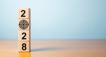 2028 Target Achievement: Wooden blocks stacked vertically spell out the year 2028, with a bullseye symbol indicating focus and goal setting for the future.