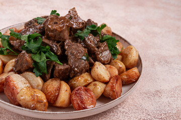 kuyrdak, roast offal with potatoes and fresh herbs, homemade in Kazakh, no people,